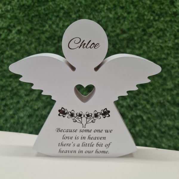 Front view of white wooden memorial angel with custom engraving and cut-out heart, perfect for home decor.